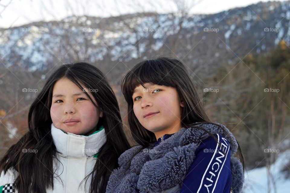 young girls posing against the background of mountains