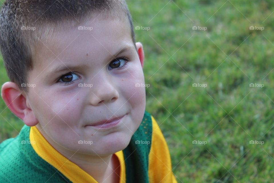 Close up of young boy in grass