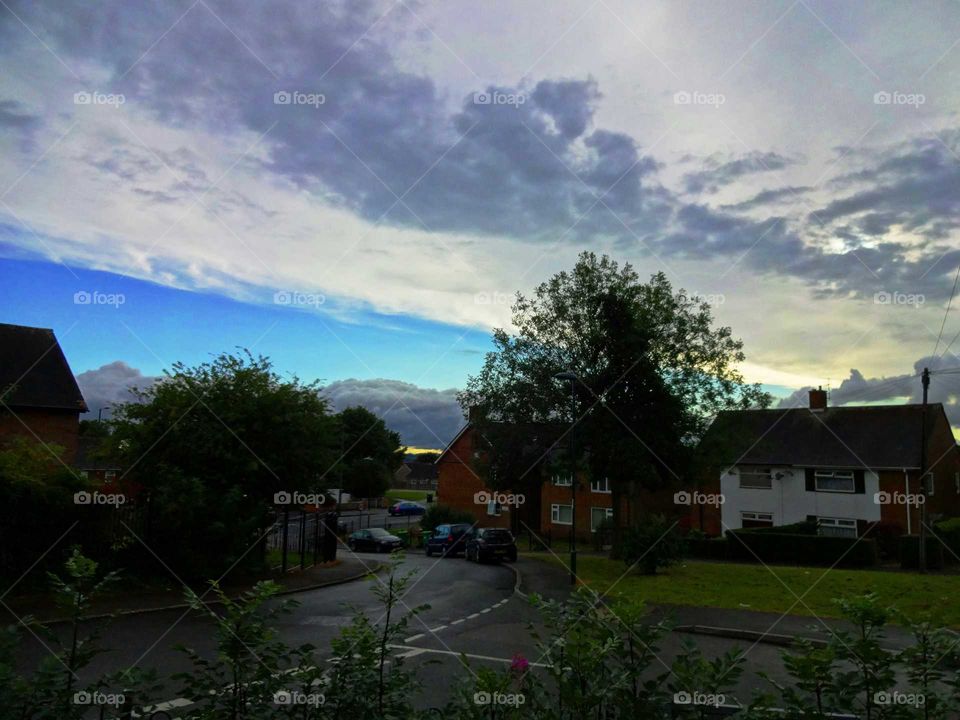 strange sky on my neighborhood. crazy sky after  a day  of rain on my neighborhood