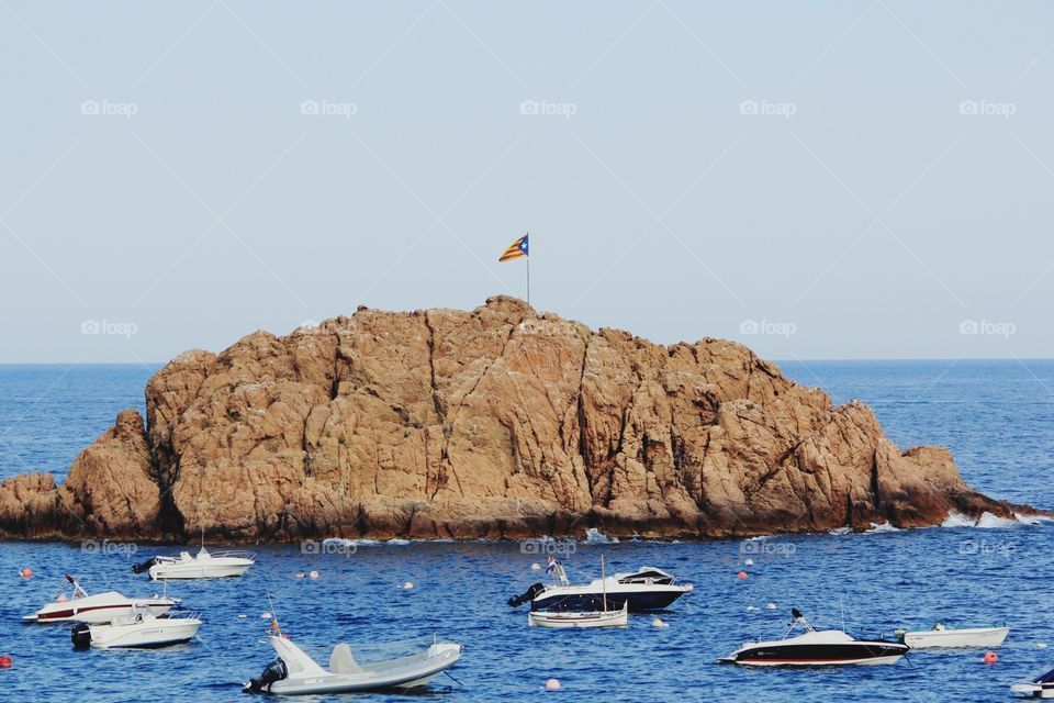 Flag on a Rock in Tossa Spain 