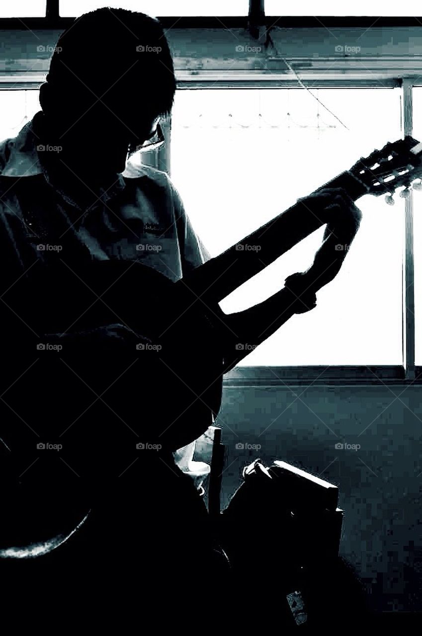 Man play guitar in silhouette