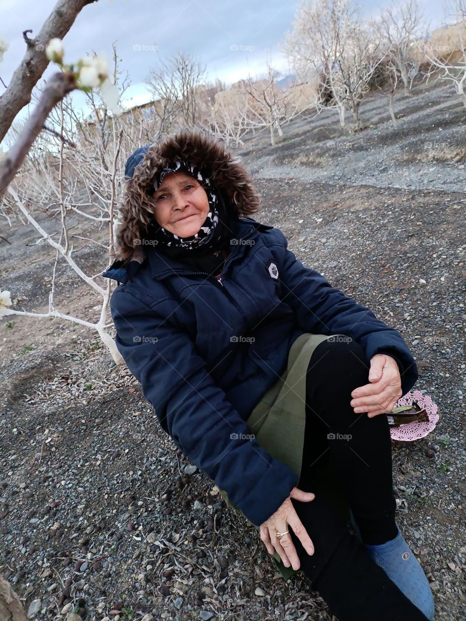 An image of a tired but smiling old mother full of love and hope