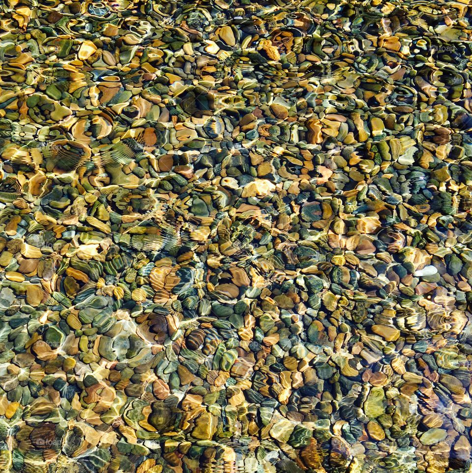 Reflection water and pebbles stone