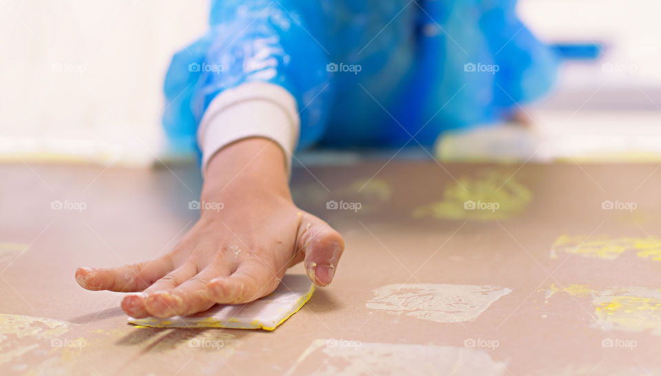 Child indoors practices engraving art.