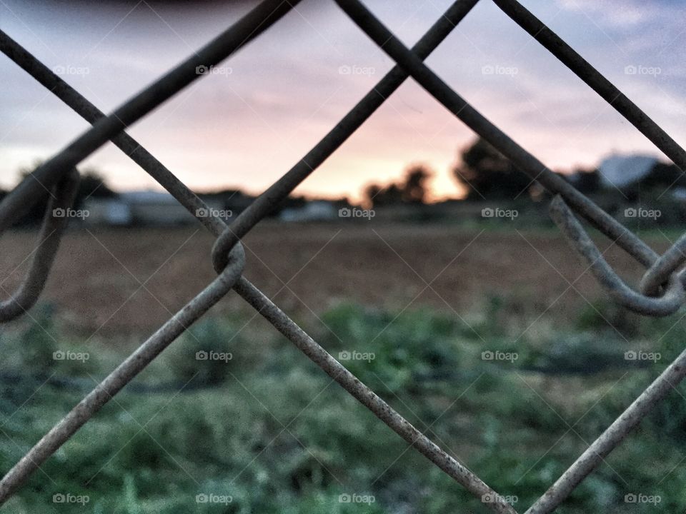 Sunset through a fence
