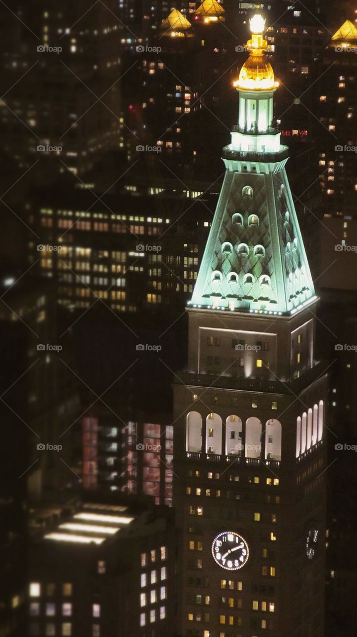 Clock Tower in the City at Night with Lights