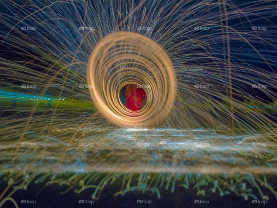This picture is someone spinning steel wool and sparks flying around. It is a long exposure so it has a very cool look to it! I added a little bit more color in photoshop to spice things up a little bit!