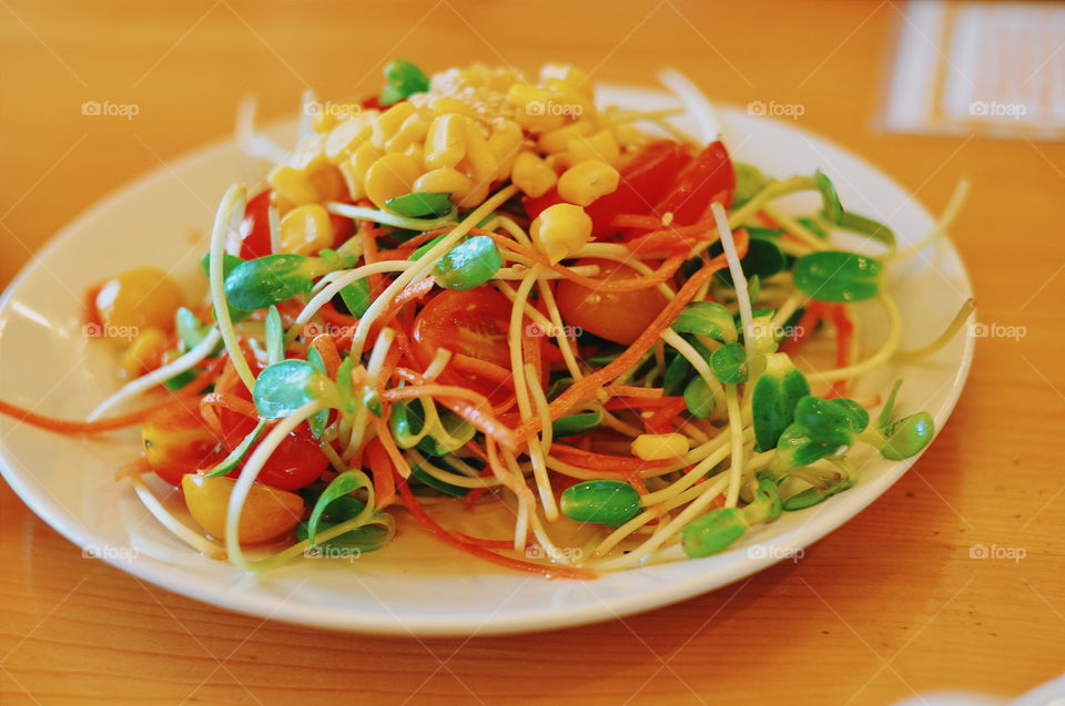 Healthy Salad. Tomatoes, corn, luttuce, sunflower leaf, and carrots. This dish will make you drools over.