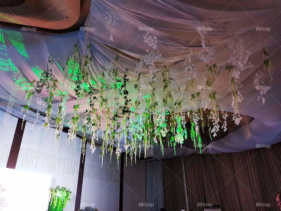Attractive and unique flower decorations in the ceiling of a party venue.