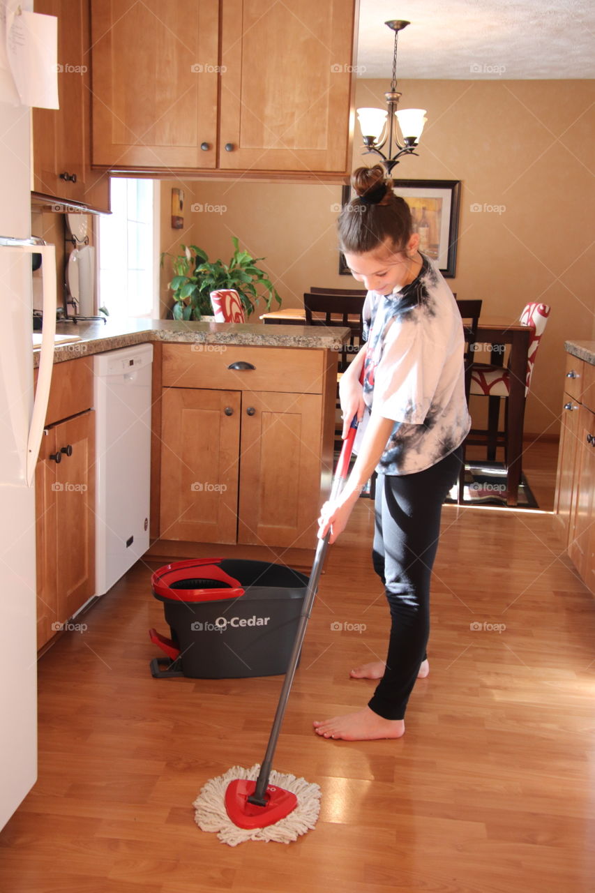 Girl using O-Cedar mop and bucket 