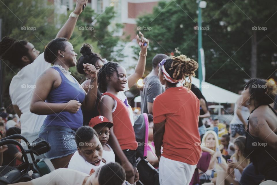 People having fun and good time together standing and gossiping at a music event in evening 