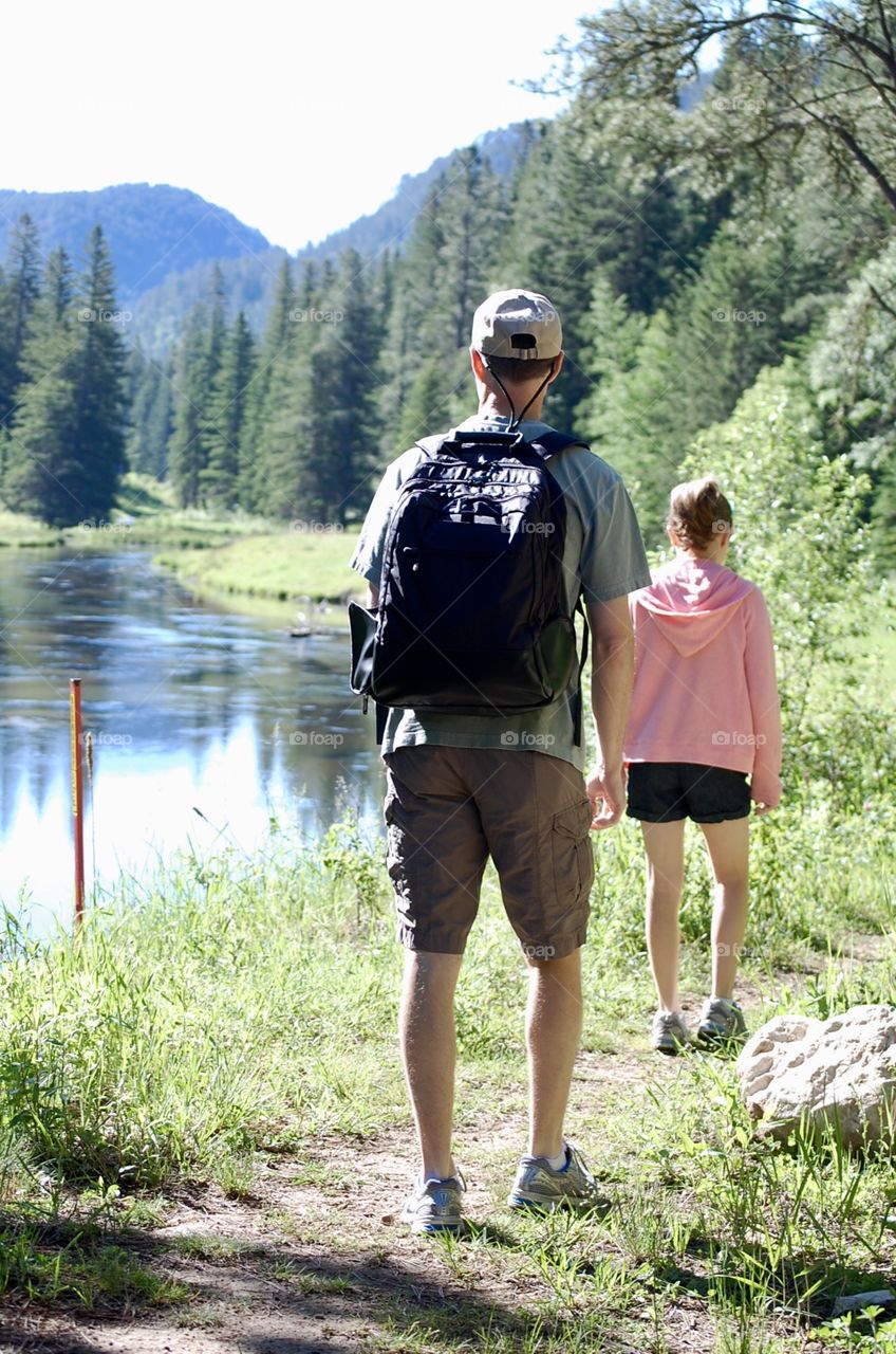 Father and daughter hiking together on a beautiful summer day through Spearfish Canyon