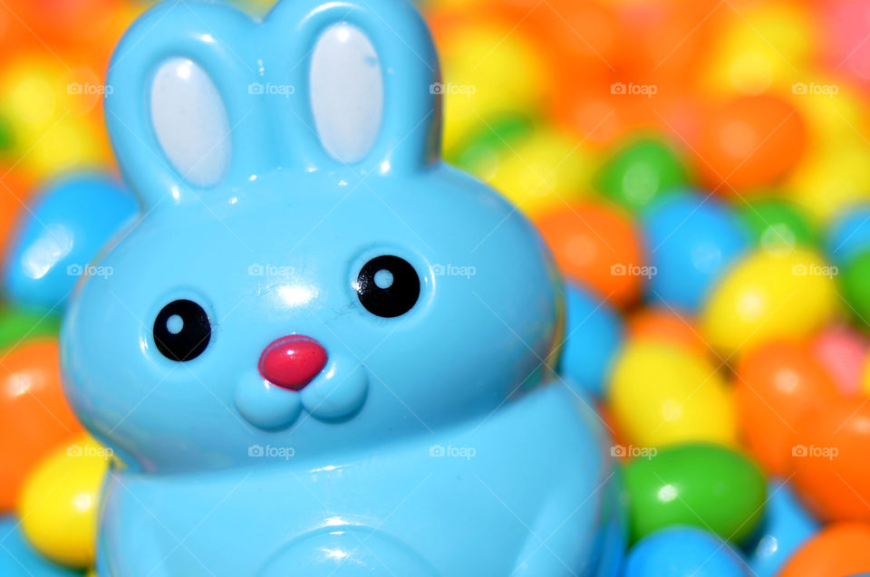 Blue Easter Bunny with colorful Easter candies. 