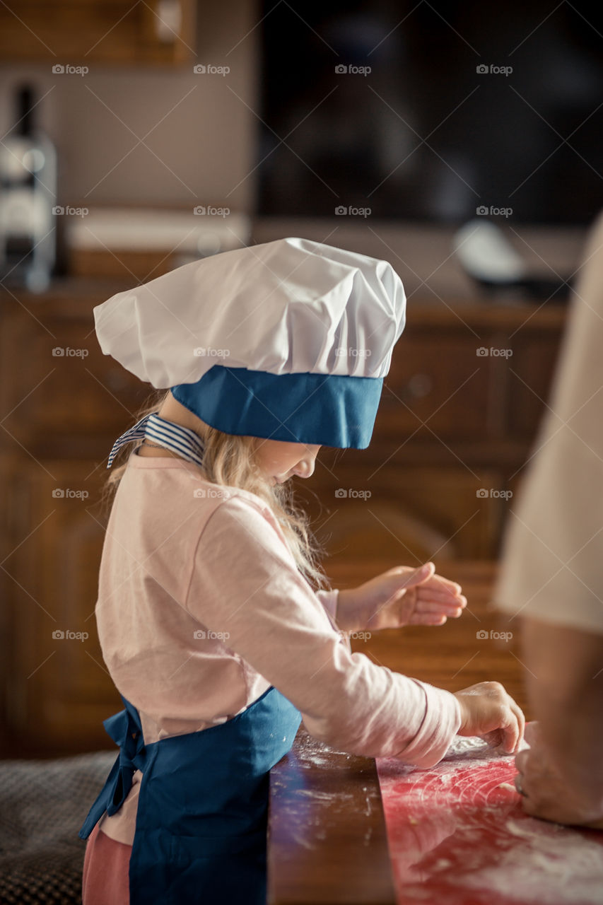 Little sisters cooking the biscuits 