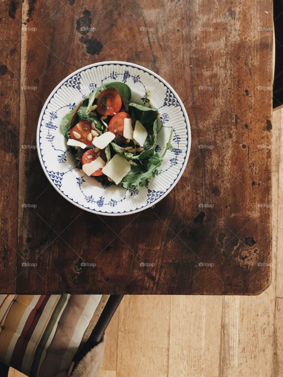 brown table with vegetable salad on white plate