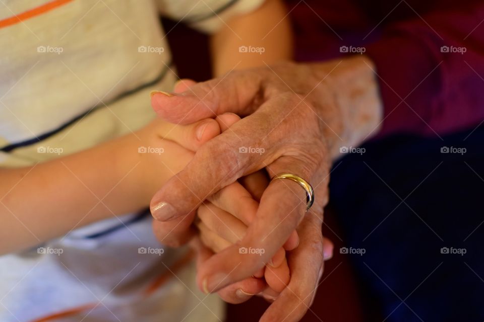old and young hands together