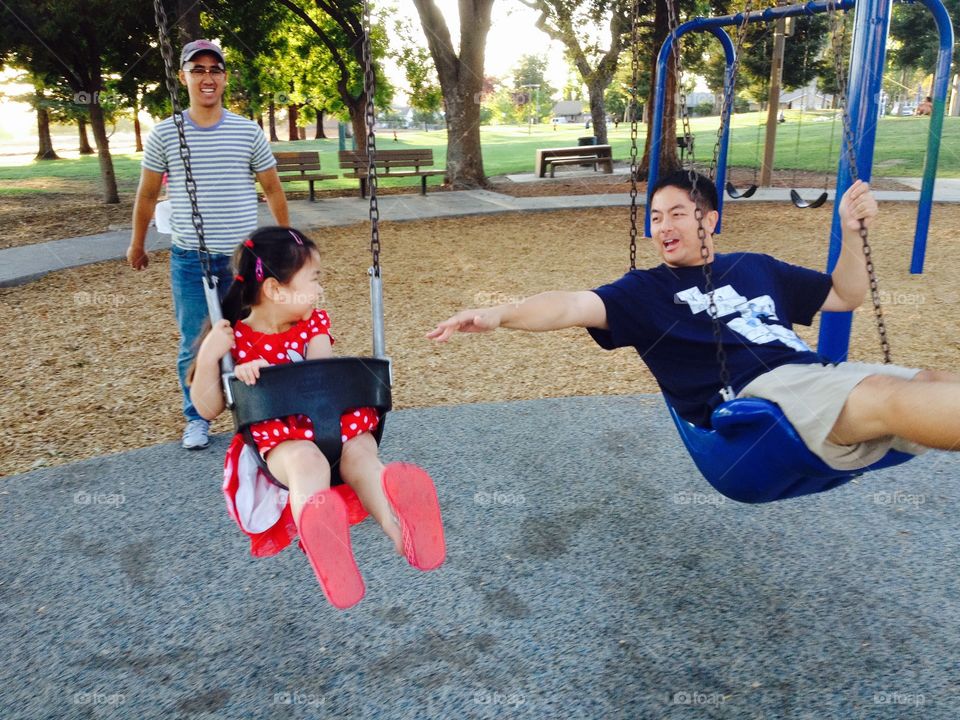 Three Generations. Swinging in the park