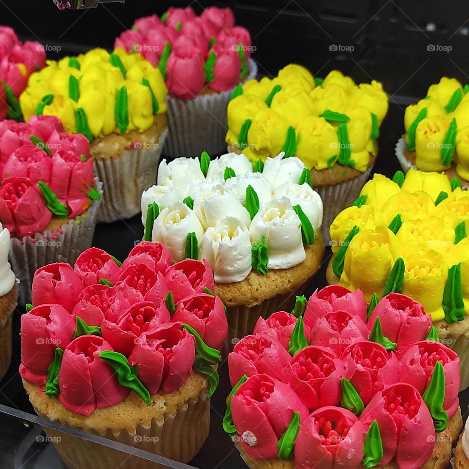 spring cupcakes with bright floral decorations