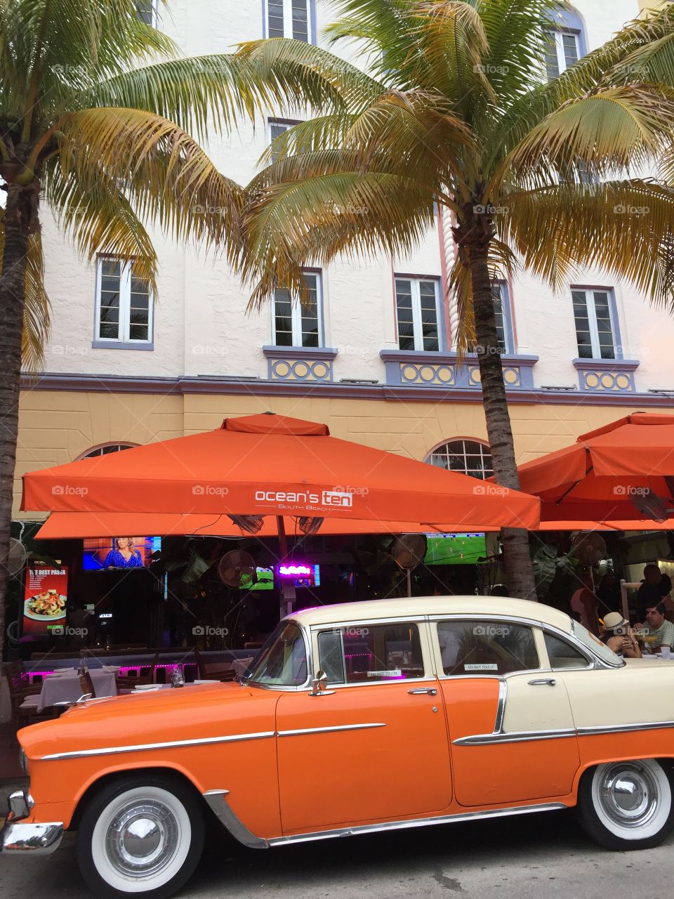 Vintage car . Vintage car parked in front of hotel on  the street, Miami Beach, Florida, USA 