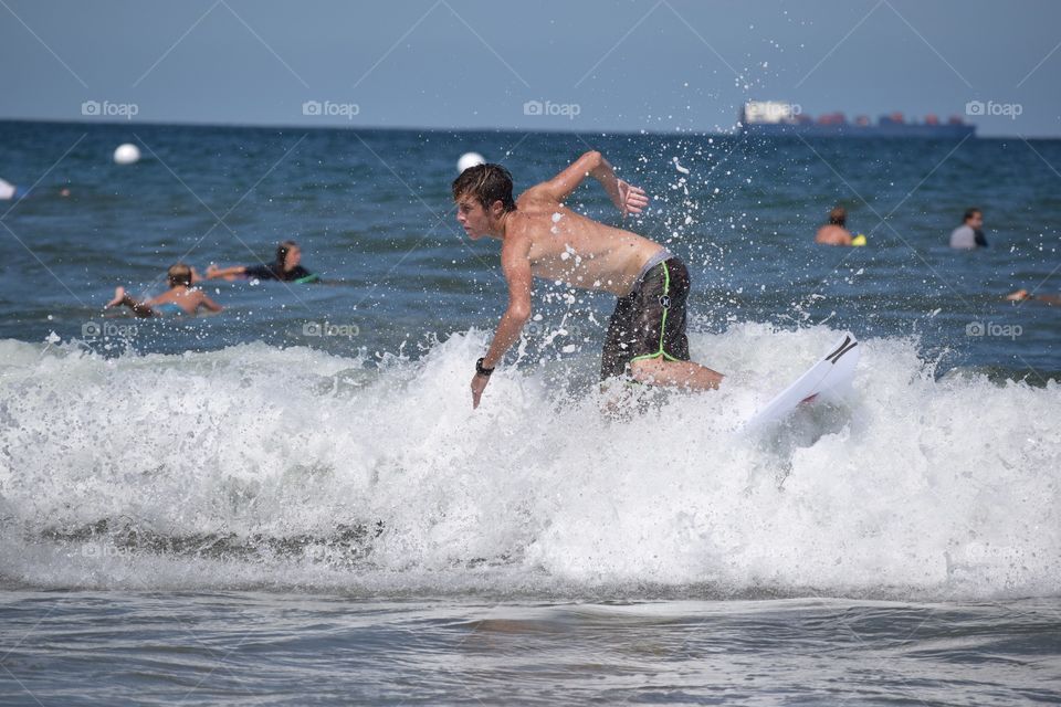 A Day of Surfing. A young man surfing.