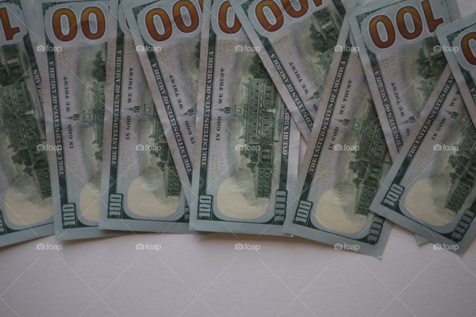 get rich. 100 dollar bills on a white background. Pile of new one hundred dollar bills bills.