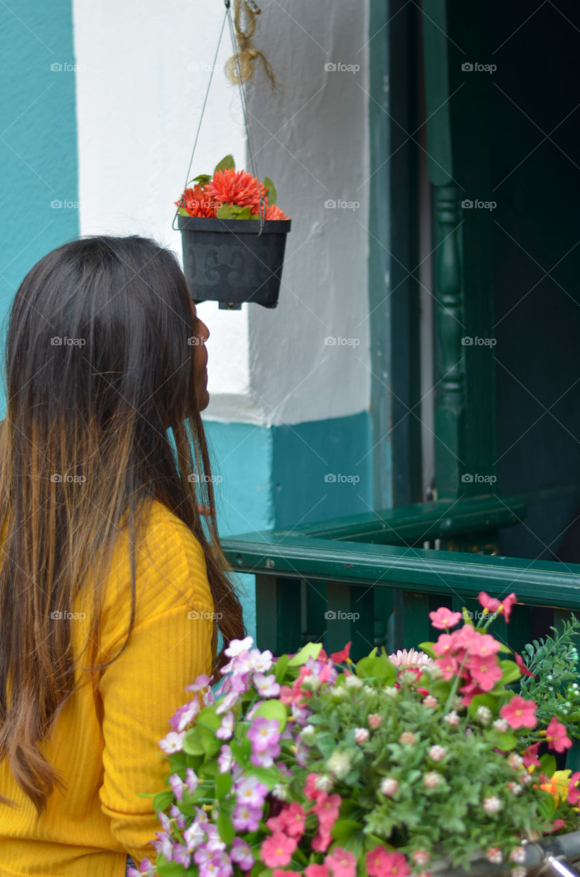 Girl looking at a flower