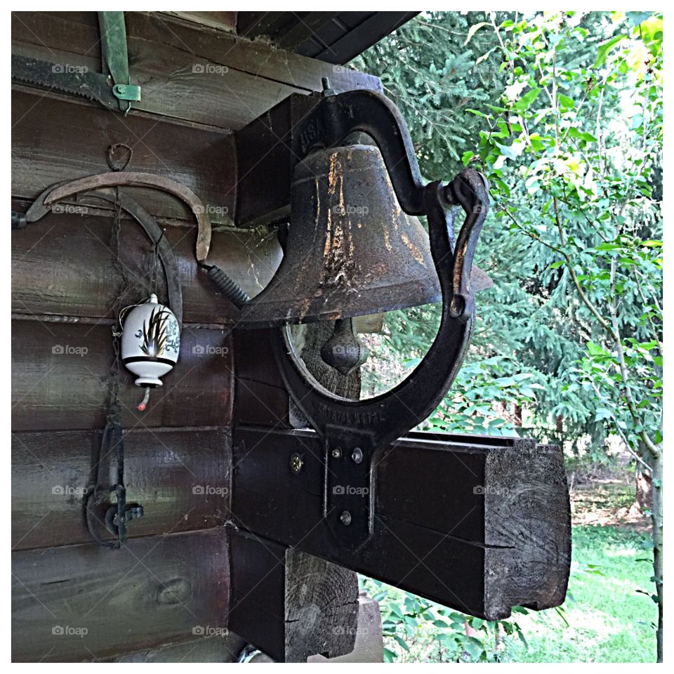 Old bell on log home