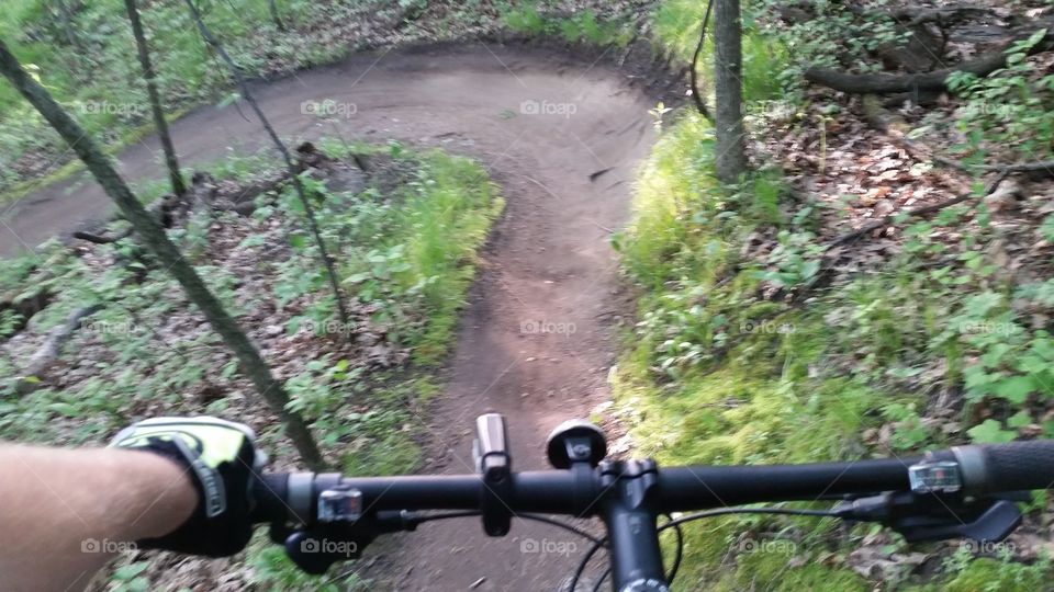 Looking past my handle bars at the huge turn a head of me on the trail.