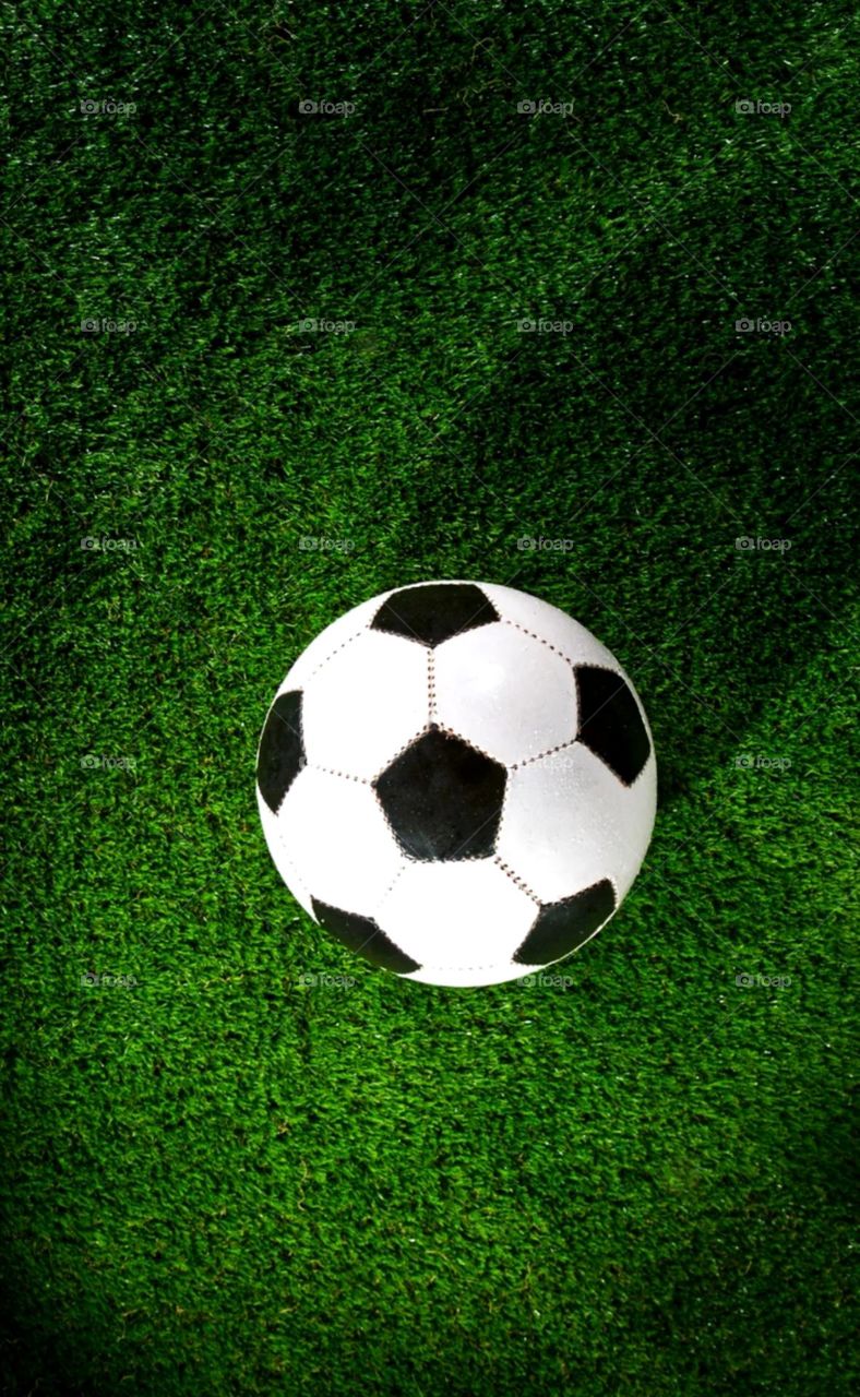 it's a sports men best ball football nice black and white colour football on gress