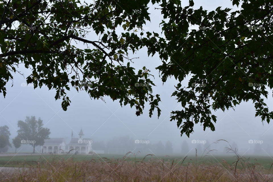building Church fog early morning grass field Dublin Ohio