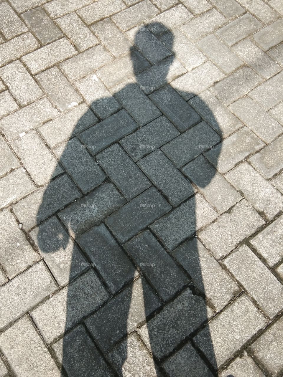 Human shadow on the paving floor