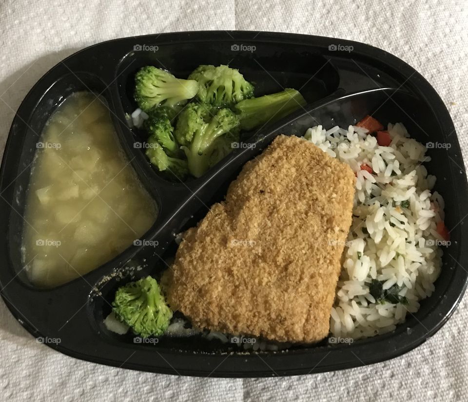 Fish, broccoli,  rice, and applesauce frozen convenience meal
