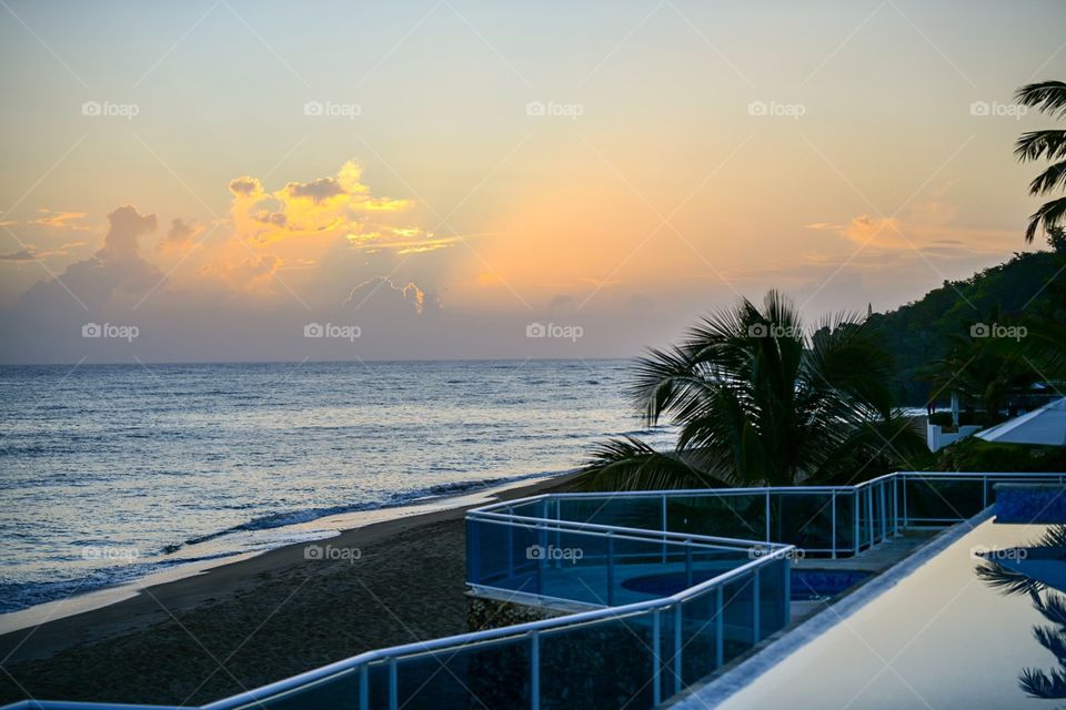 bright orange sunset at beach in sosua dominican republic