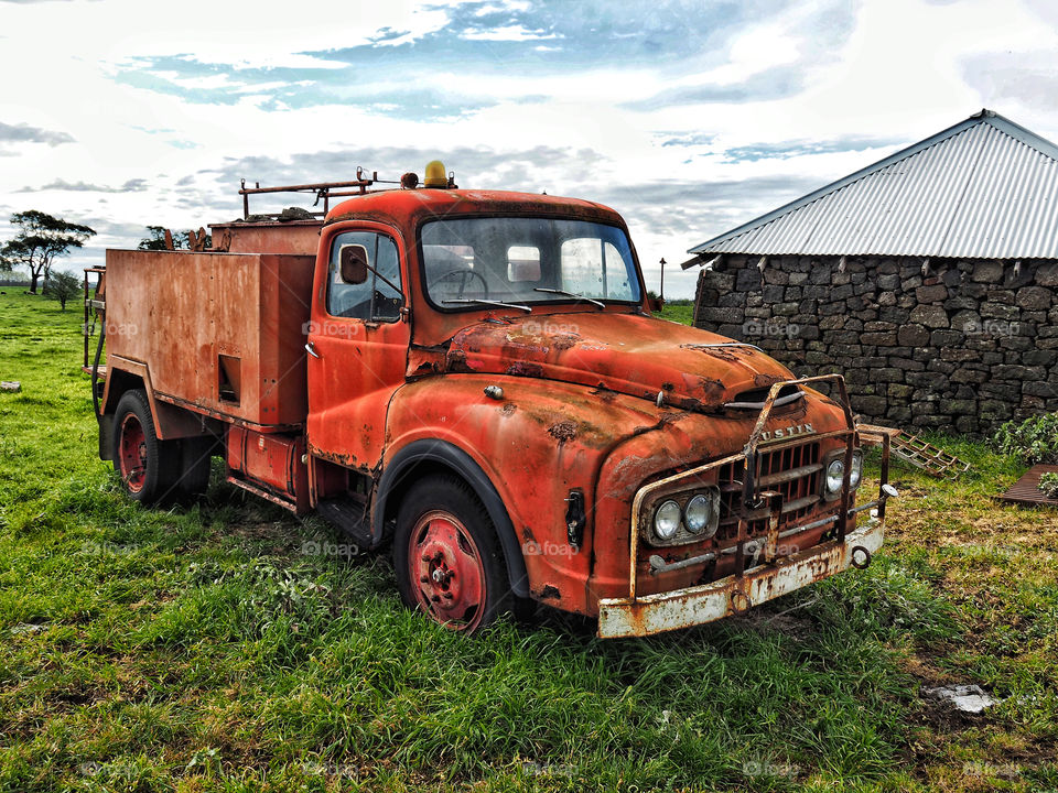Old red Austin truck on a farm 