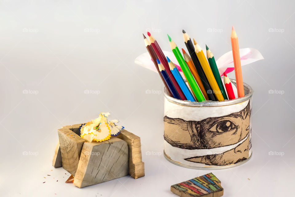 Crayons and fluffy little balls in white background