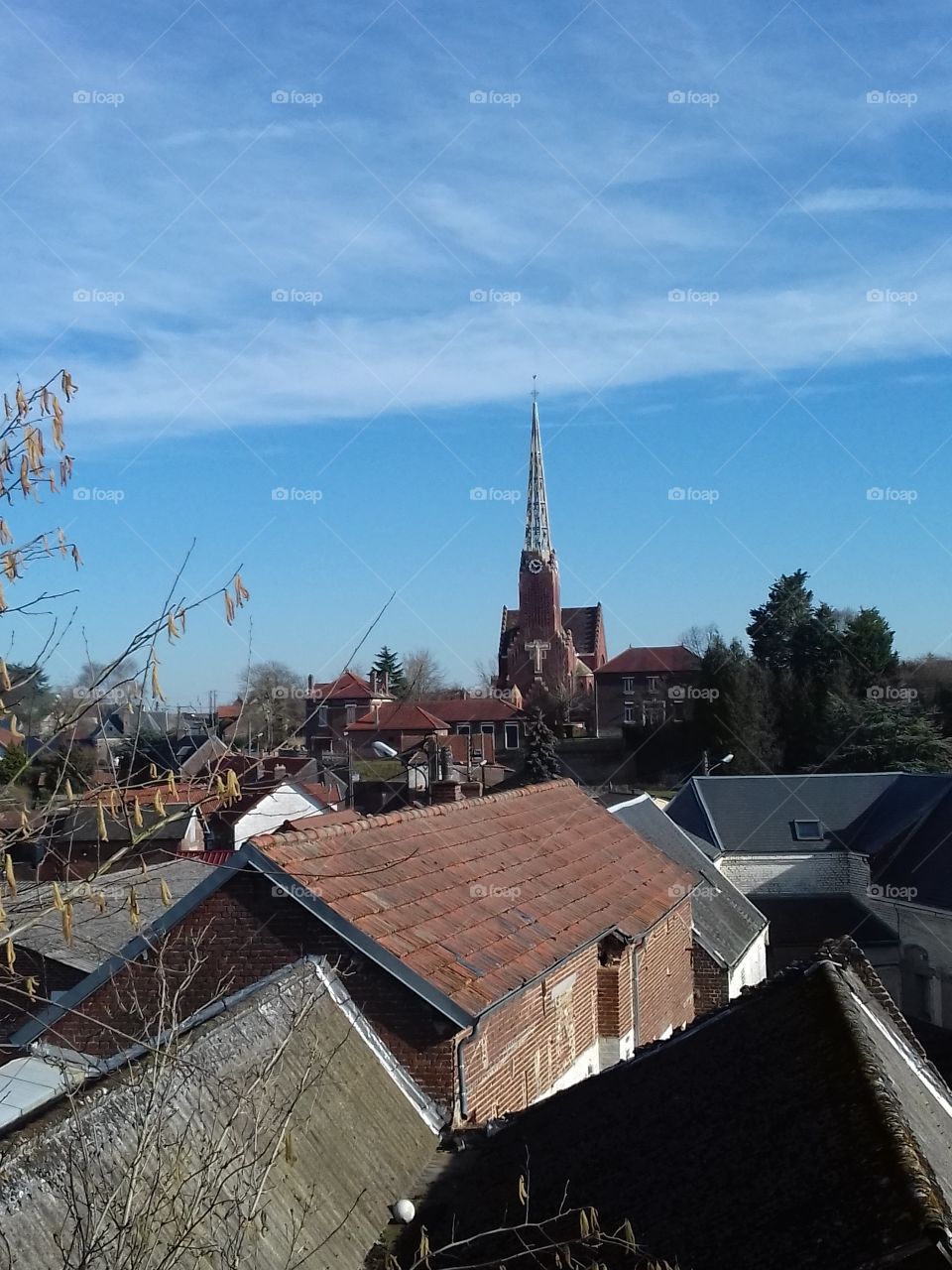 view of the blue sky, church and the houses in amiens france
