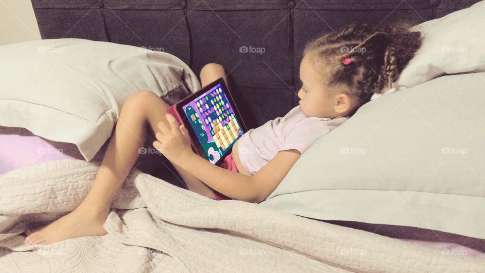 Child playing with Ipad