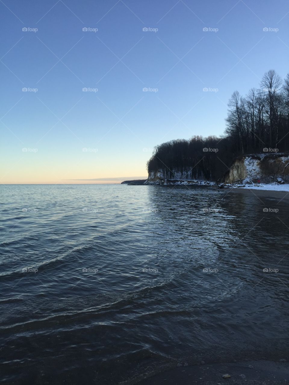 Peaceful waves crashing along the icy shore 