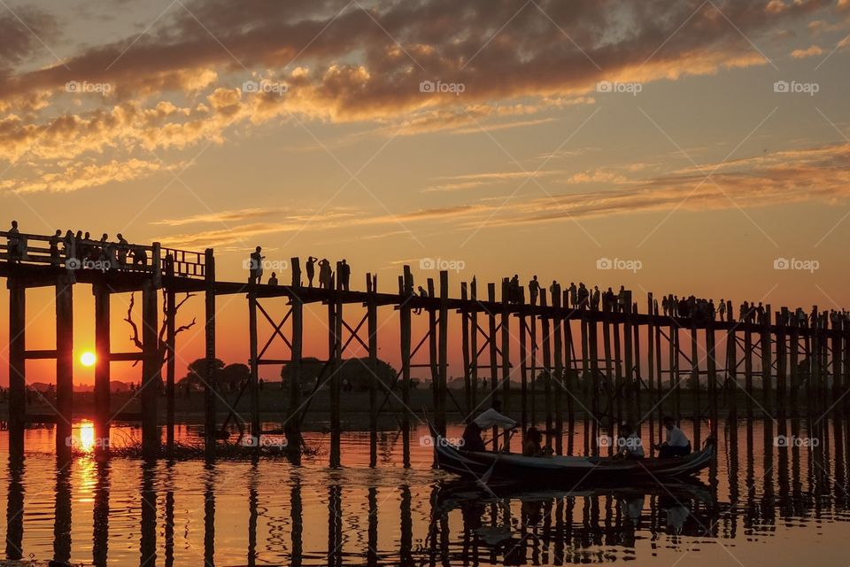 Silhouette of people on jetty during sunset