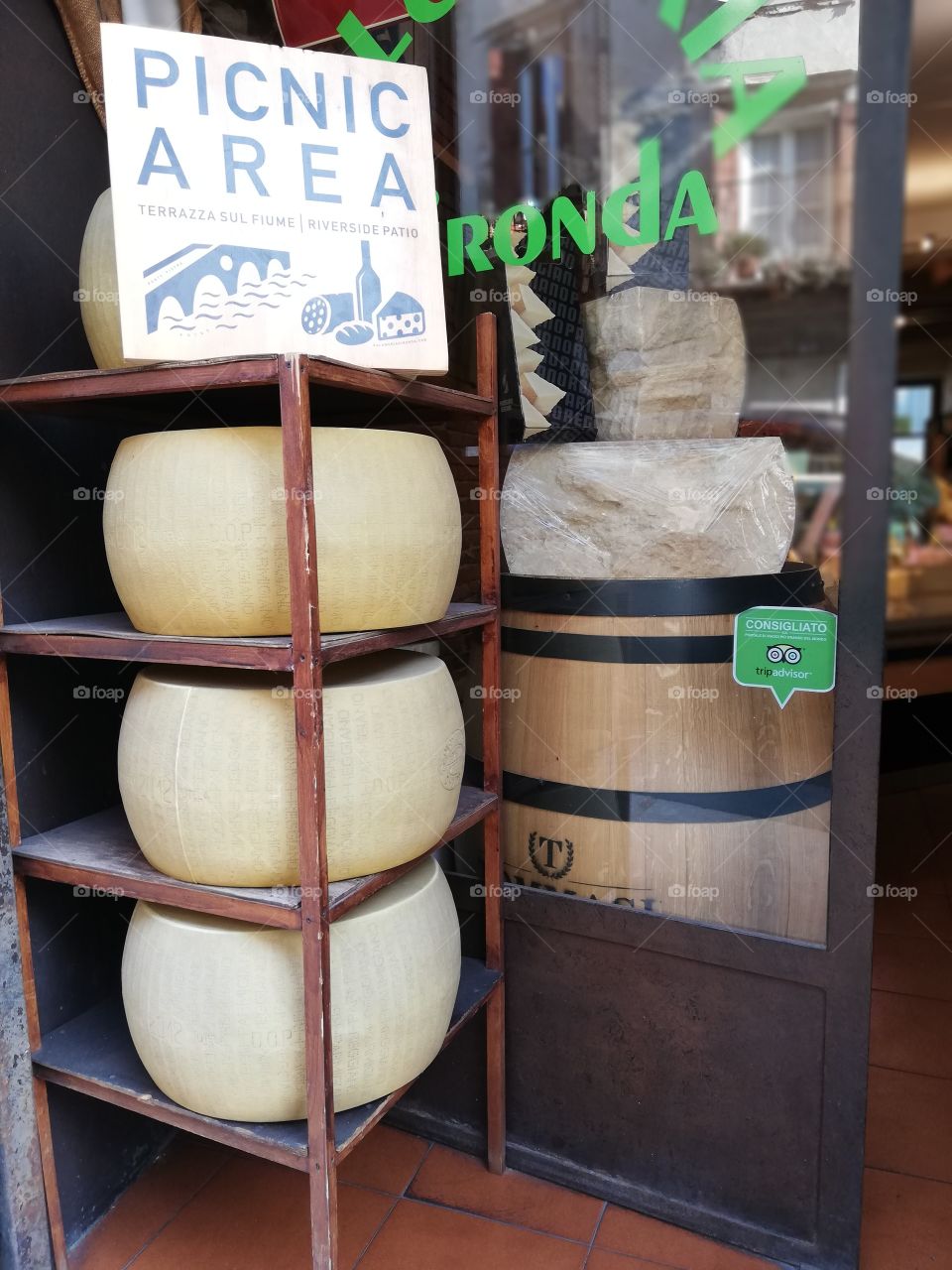 Small shop with large forms of Parmesan cheese