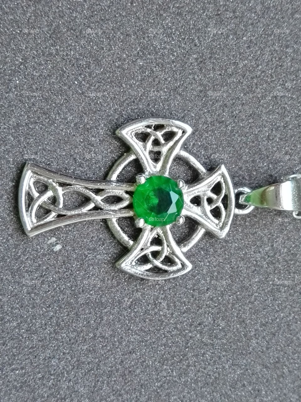 silver Celtic cross with green stone