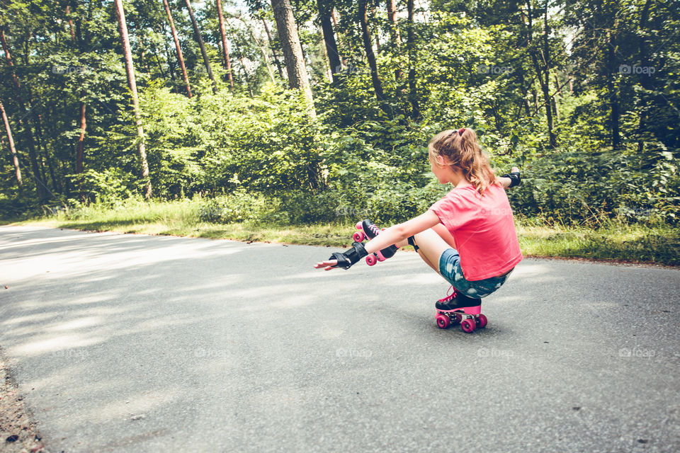 Girl roller-skating on street