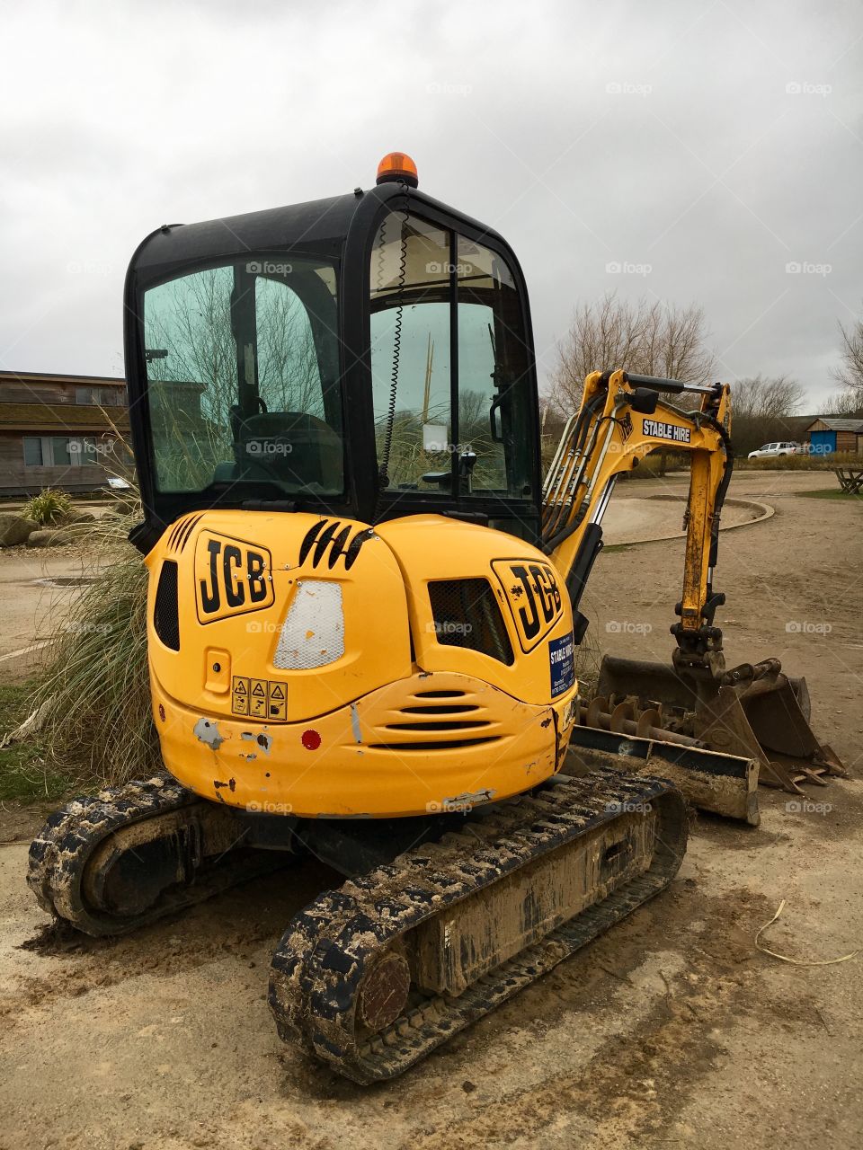 Yellow JCB on a cloudy day 