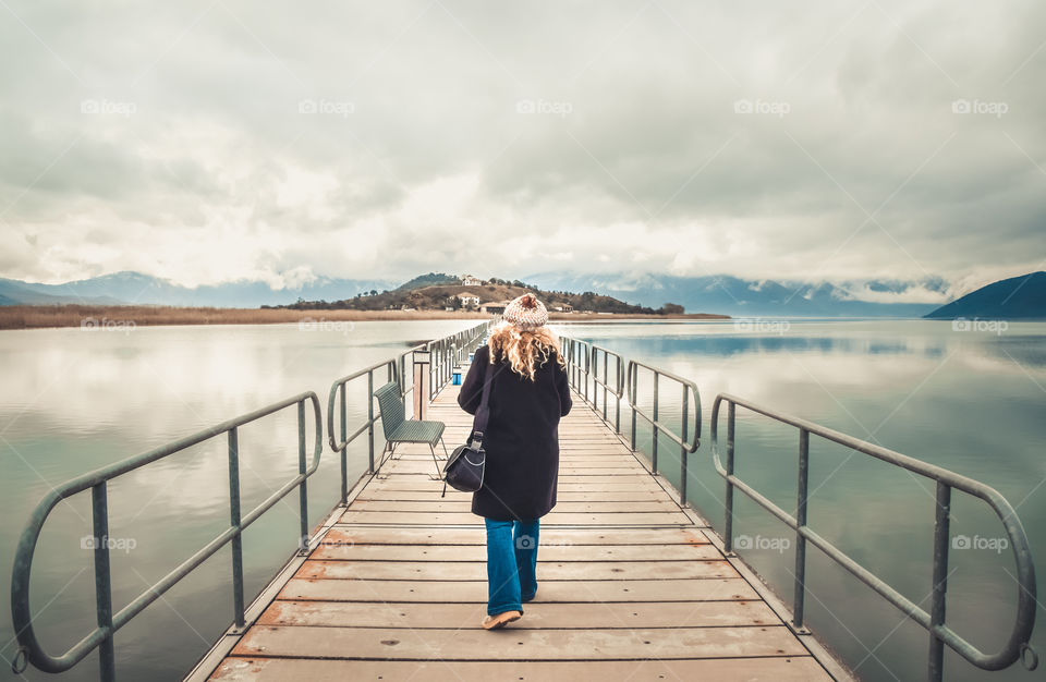 Wanderlust Young Woman Walking On Bridge Toward The Island
