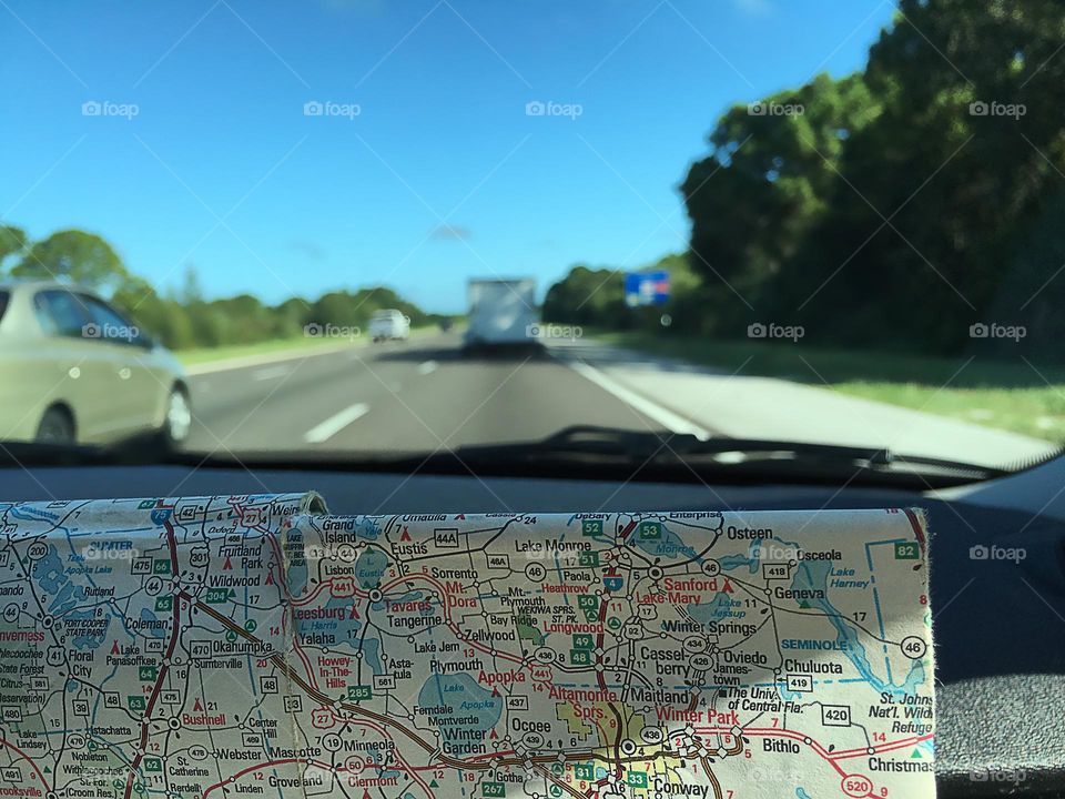 Commuting by car with map.