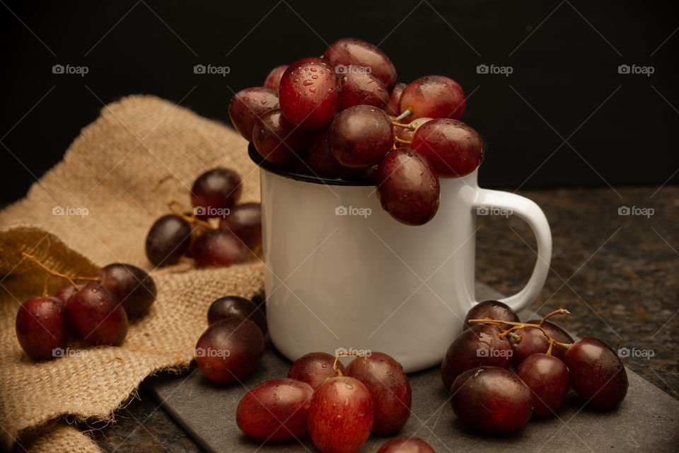 grapes in a white cup