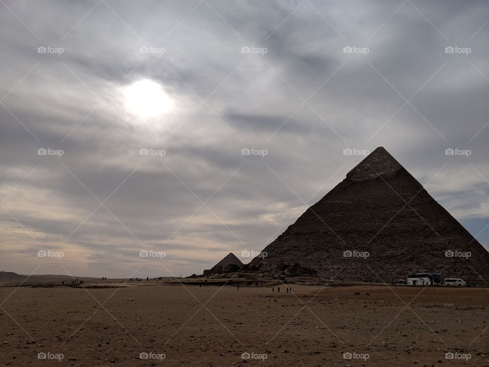 The sun going down behind the oyraids of Giza, Egypt