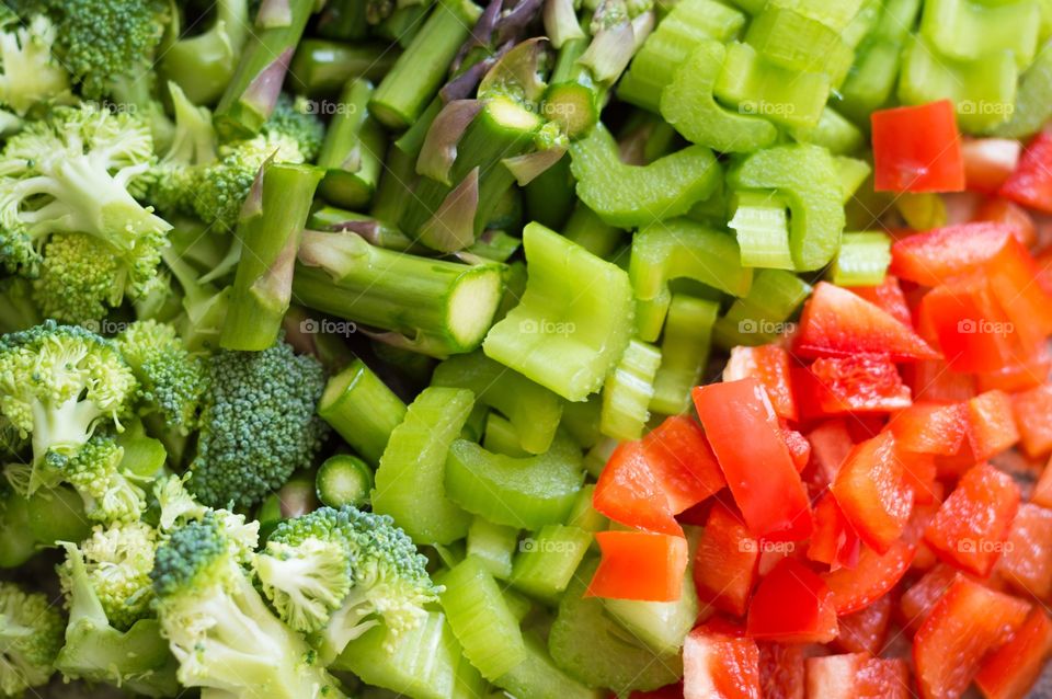 Close up of fresh vegetables cut up and ready to be cooked.