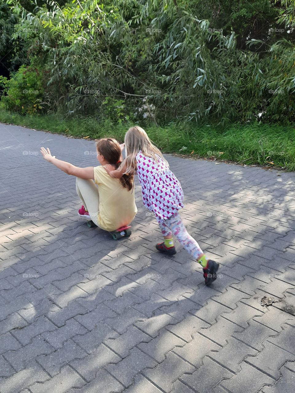 kids walking and playing down the street