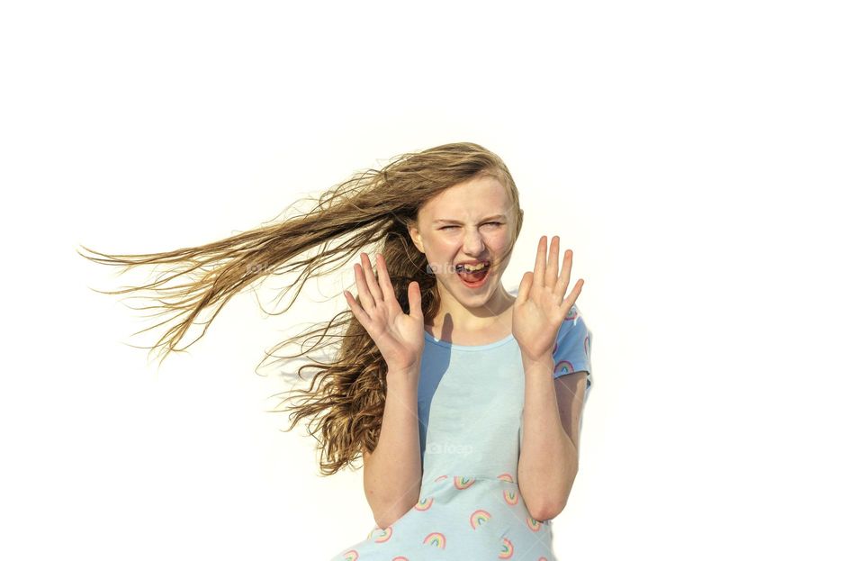 Girl surprised as wind blows her hair